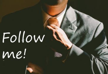 Man in a suit with text of Follow Me!