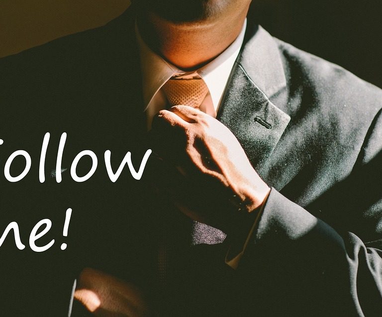 Man in a suit with text of Follow Me!