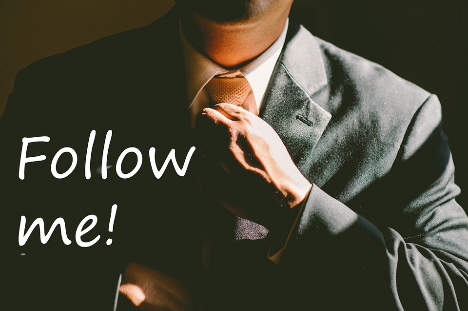 Man in a suit with text of Follow Me!