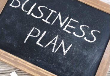 Chalkboard with "business plan" written in chalk