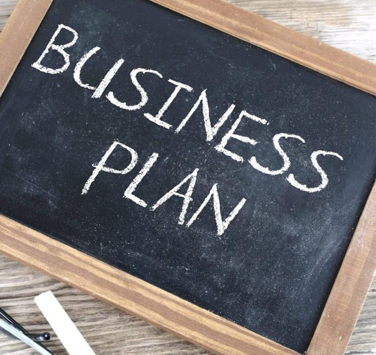 Chalkboard with "business plan" written in chalk