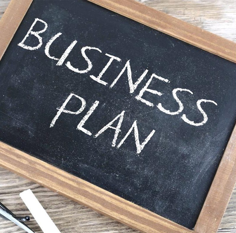 Chalkboard with "business plan" written in chalk