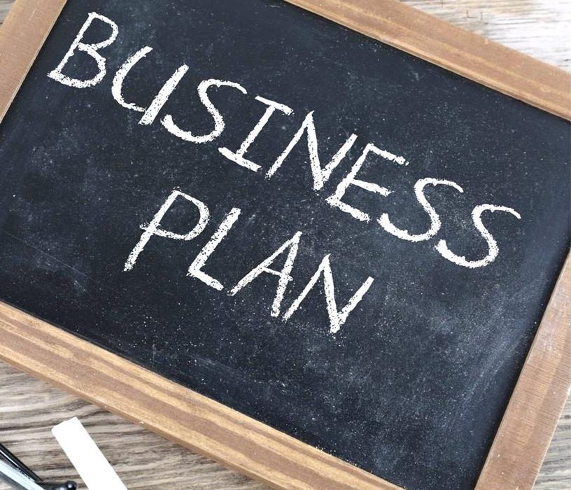 Chalkboard with "business plan" written in chalk